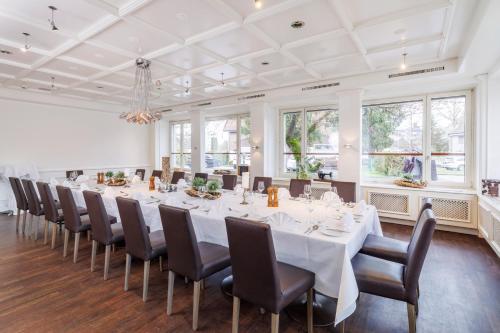 a large room with a long table and chairs at Sorell Hotel Sonnental Dübendorf in Dübendorf