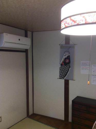 a room with a door with a fish on the wall at Hanakiya in Kyoto