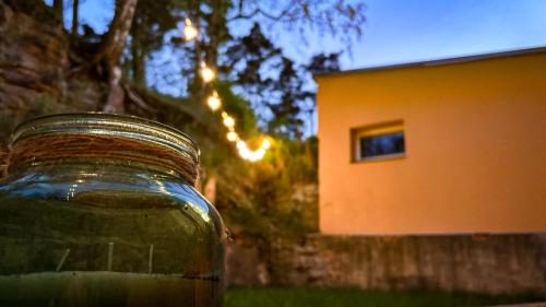 a jar of liquid sitting in front of a house at Remote Work Friendly Zahradní apartmán u jezera in Staré Splavy