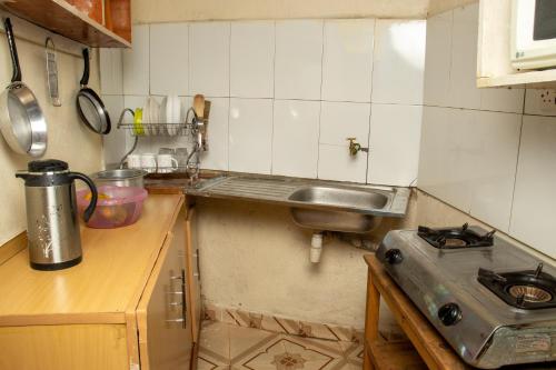 a small kitchen with a sink and a stove at Hilda's place in Embu