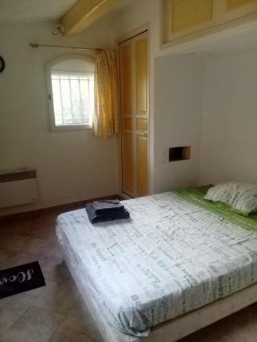 a bedroom with a large bed and a window at chambre indépendante avec salle de bains privative in Grasse