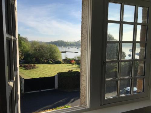 an open window with a view of the water at La Grimaudière in La Chapelle-sur-Erdre