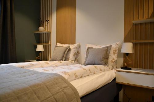 a bedroom with two beds with pillows at Andenes Suitehotel in Andenes