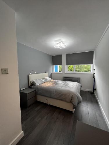 a bedroom with a bed and a window at Stylish Stays - Luxury Apartment for 3 in Manchester