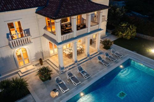 an aerial view of a house with a swimming pool at La Villa Dubrovnik in Trsteno