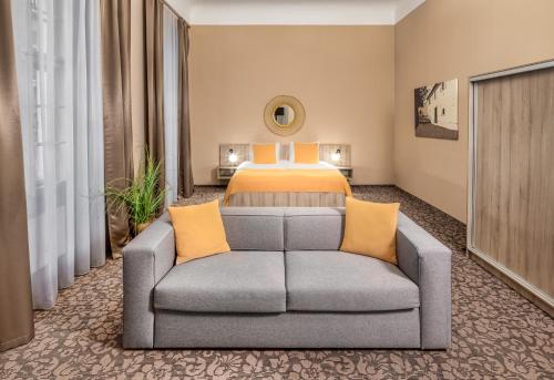 a hotel room with a bed and a couch at Hotel "Palác U Kočků" by Adrez, Palace At the Cats in Prague
