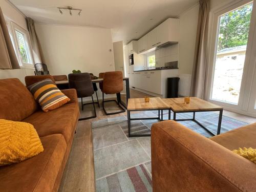 a living room with a couch and a table at Vakantiepark Hertenhorst in Beekbergen