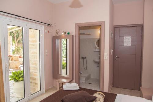 a bathroom with a bed and a shower and a toilet at Fantastic Matala 1 in Matala