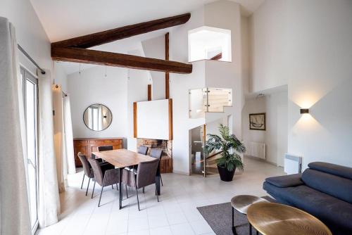 un salon avec une table et un canapé bleu dans l'établissement La Maison Mediterranéenne, T4, Terrasse, clim, pkg, à Montpellier