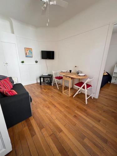 un soggiorno con tavolo e divano di Very Quiet and Cosy apartment a Saint-Ouen