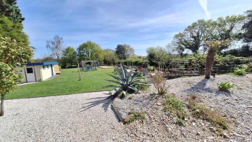 a garden with a playground and a house at MOR-HA-MARCH Chambres d'Hôtes in Sarzeau