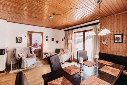 a living room with a wooden ceiling and a table at Chalet Familie Mertel in Ebene Reichenau in Ebene Reichenau