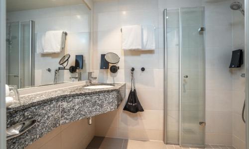 a bathroom with a sink and a shower at Thon Partner Stavanger Forum Hotel in Stavanger