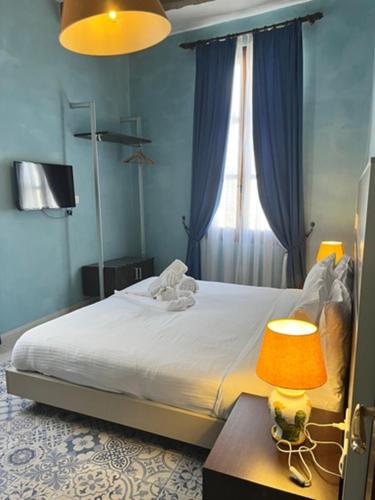 a bedroom with a bed with a lamp and a window at My Travel House in Rabat