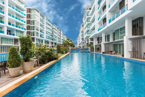 a swimming pool in front of some apartment buildings at 3 bedrooms My resort huahin with free waterpark in Hua Hin