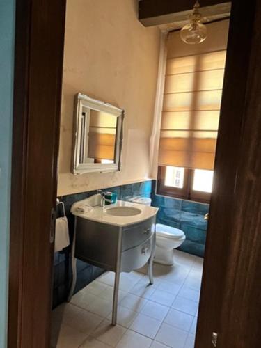 a bathroom with a sink and a toilet and a mirror at My Travel House in Rabat