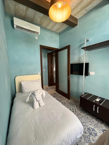 a bedroom with a bed with a white blanket at My Travel House in Rabat