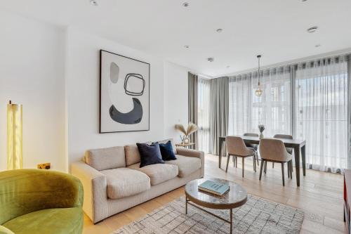 a living room with a couch and a table at Modern King's Cross Apartments in London