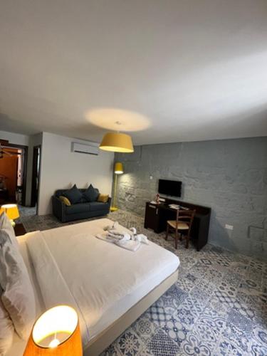 a bedroom with a bed and a desk and a couch at My Travel House in Rabat