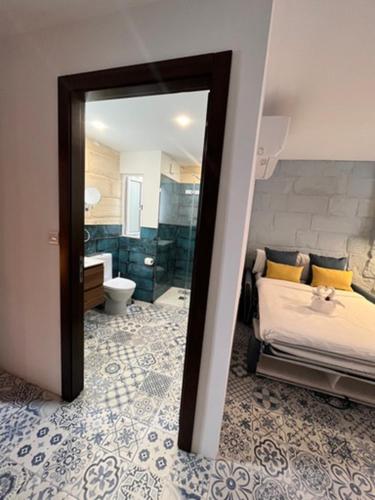 a mirror in a bedroom with a bed and a bathroom at My Travel House in Rabat