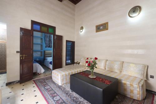 a living room with a couch and a table at Riad Dwiriyat My Teib in Marrakech