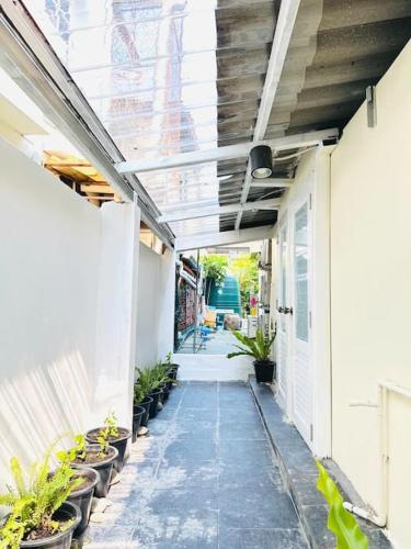 a hallway of a building with potted plants at Chubby 5 Room 4 in Ban Bang Bamru
