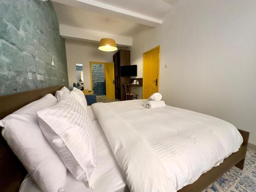 a bed with white sheets and pillows in a room at My Travel House in Rabat