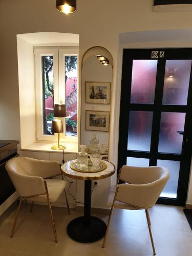 a dining room with a table and chairs and a mirror at Split Old Town Oasis in Split