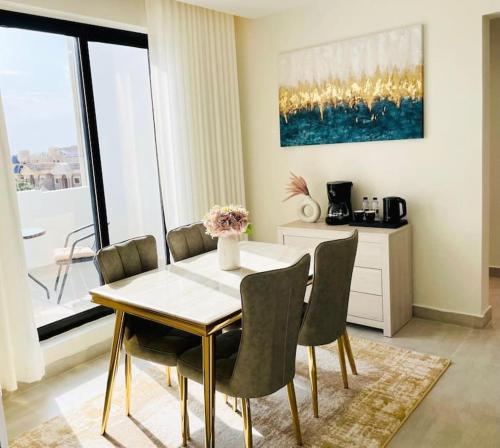 ein Esszimmer mit einem weißen Tisch und Stühlen in der Unterkunft Spacious new 2 bedroom Apt-in amazing location B33 in Riad