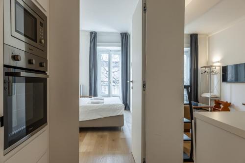 a kitchen and a bedroom with a bed and a window at Sant'Andrea Charme Apartments in Milan