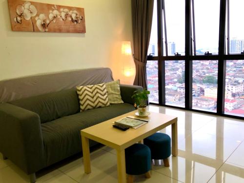 a living room with a couch and a table at Icon Residenz Icon City, Petaling Jaya by De Harlequins Guesthouse in Petaling Jaya