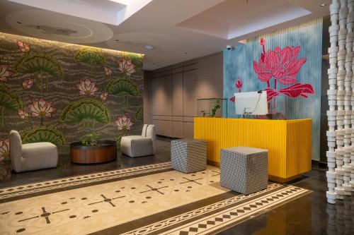 a lobby of a hotel with a colorful wall at Zibe Luxe Kakinada by GRT Hotels in Kākināda