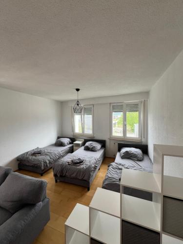 a living room with two beds and a couch at City Unterkunft 3 in Heilbronn