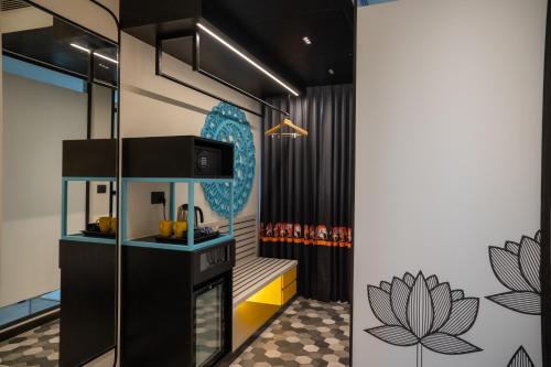 a bathroom with a counter and a sink in a room at Zibe Luxe Kakinada by GRT Hotels in Kākināda