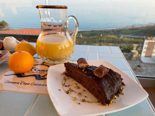 a piece of chocolate cake and a jug of orange juice at Re Mare B&B in Crotone