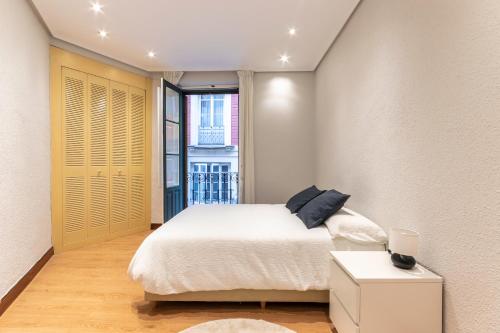 מיטה או מיטות בחדר ב-Apartamento Uribitarte