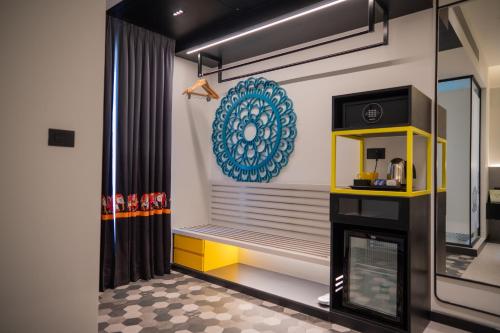 a living room with a fireplace and a mirror at Zibe Luxe Kakinada by GRT Hotels in Kākināda