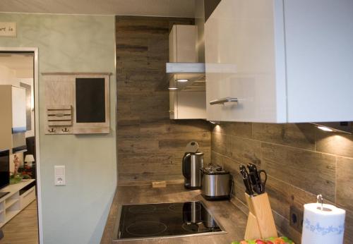 a kitchen with white cabinets and a stove top oven at Palatium Bad Ems in Bad Ems