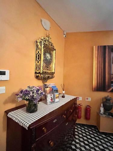 a room with a dresser with a clock on the wall at My Travel House in Rabat