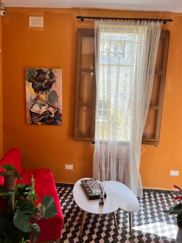 a living room with a red couch and a window at My Travel House in Rabat