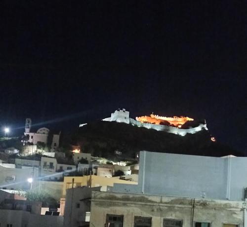 a castle on top of a mountain at night at Castle view in Panteli