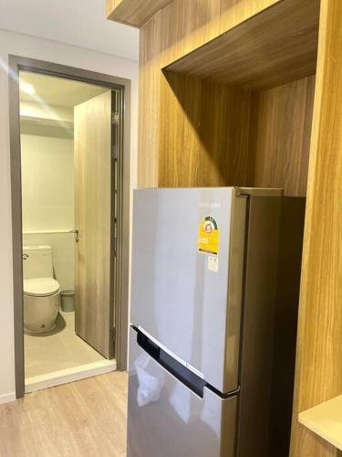 a refrigerator in a room with a toilet at Siamese 87 2BR 素坤逸 BTS On Nut LOFT 两房 25 in Bangkok