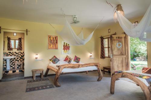 a bedroom with a bed in a room at Lake Natron Maasai giraffe eco Lodge and camping in Mtowabaga