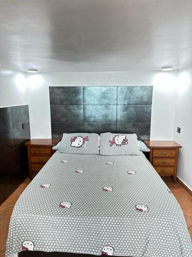 a bedroom with a large bed with polka dot sheets at "Seaside Studio with Stunning Views in Belyounech in Belyounech 