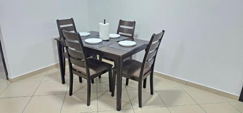 a dining room table with four chairs and a table and chairsuggest at La Paloma Blanca 06 in Tetouan