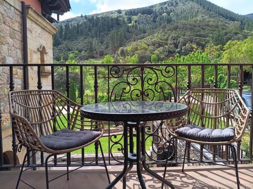 a table and chairs on a balcony with a view at Hotel Finca Malvasia - Adults only in Cabezón de Liébana