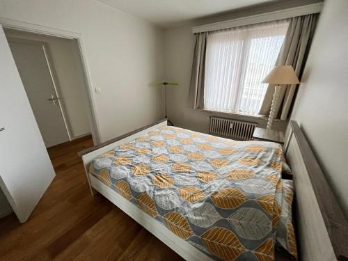 una camera con un letto con una trapunta sopra di Spacious 2 Bedroom App in the Center with Balcony a Gand