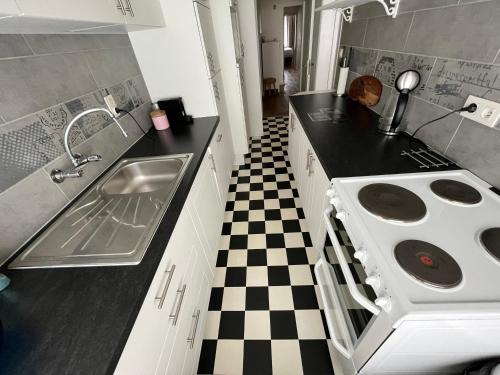 a kitchen with a stove and a sink at Spacious 2 Bedroom App in the Center with Balcony in Ghent