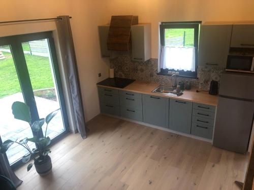 a kitchen with a sink and a refrigerator at Domek Zgredek in Żywiec