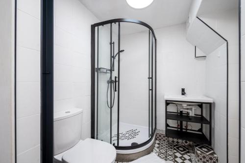 La salle de bains est pourvue d'une douche, de toilettes et d'un lavabo. dans l'établissement GuestReady - One modern stay in Kensington, à Londres